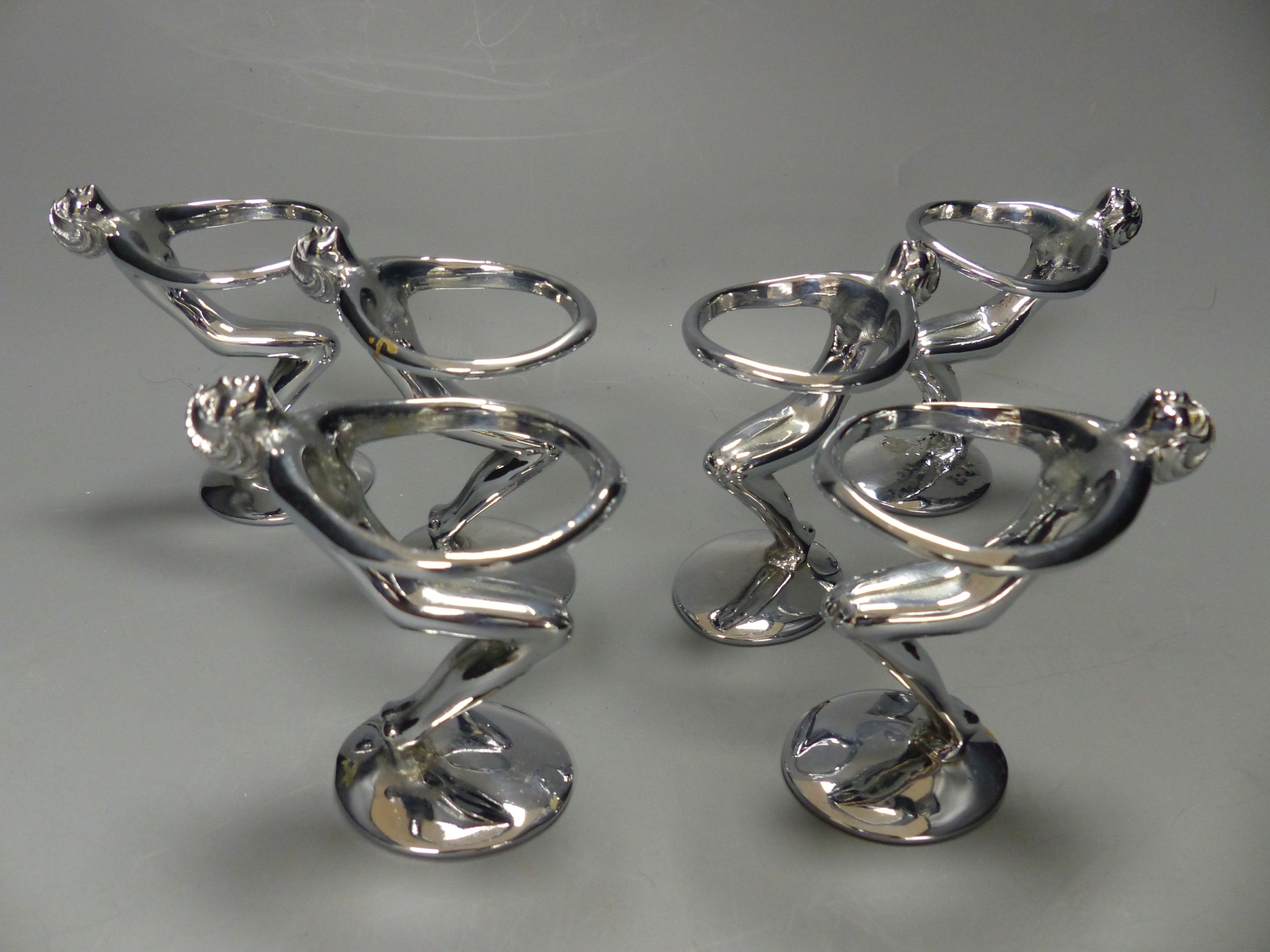 A post war chrome set of six figural egg holders, height 9cm